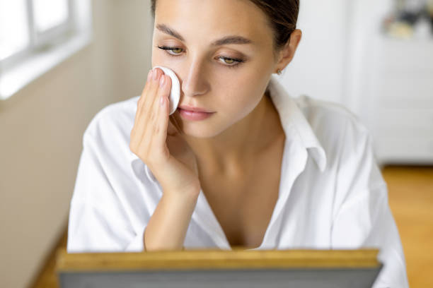 istock Woman using cotton pads for cleaning face 1879241371