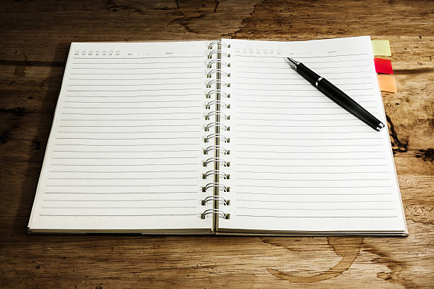 istock Openl book and pen on a wood background. 187924370