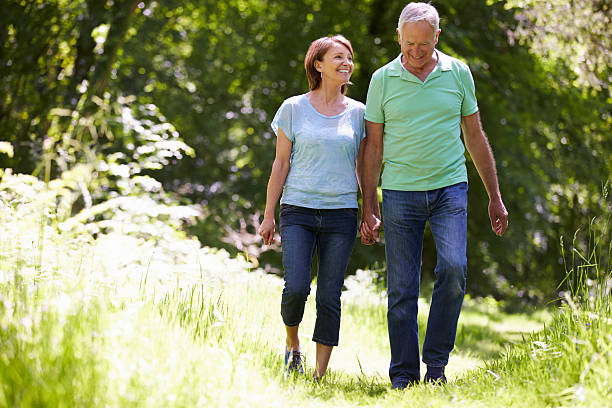 istock Senior couple walking in Summer countryside 187924429