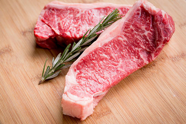 istock Raw Marbled New York Steaks 187924952
