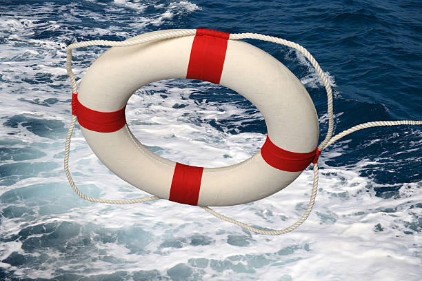 istock Life Preserver Falling On Turbulent Water 187925248