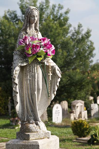 Marble Madonna in cemetery stock photo