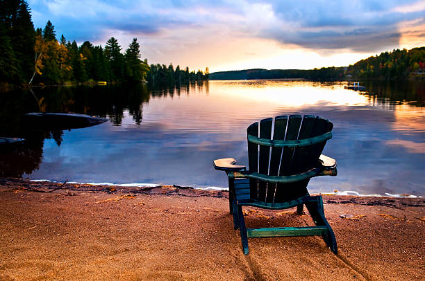 istock Wooden chair at sunset on beach 187926095