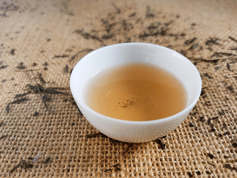 Tastings of dried tea leaves from around the world and a cup of hot brewed tea, a beverage that is a healthy drink. Varieties are from China, Japan, Sri Lanka, and India, and include green and black teas such as jasmine, oolong, gunpowder, darjeeling, roasted rice, and dragon well selections.