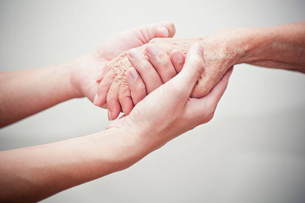 Elderly hand and caregiver