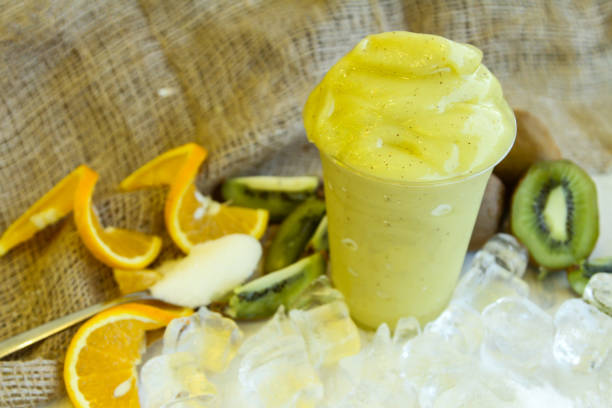 istock orange and kiwi smoothie served in disposable glass with ice cube isolated on table side view of healthy morning smoothie drink 1879296185