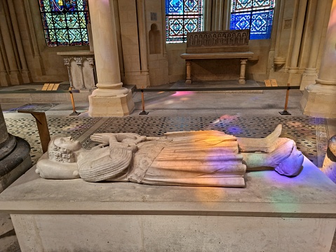 The Basilica of Saint-Denisis a large former medieval abbey church and present cathedral in the commune of Saint-Denis, a northern suburb of Paris. The church was completed in 1144 and widely considered the first structure to employ all of the elements of Gothic architecture. The image shows a tomb inside the cathedral.