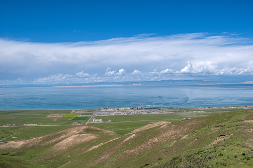 Qinghai Lake, grassland, and town under the blue sky and white clouds