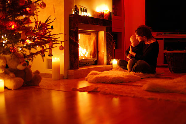 istock Young mother and her daughter by a fireplace 187934189
