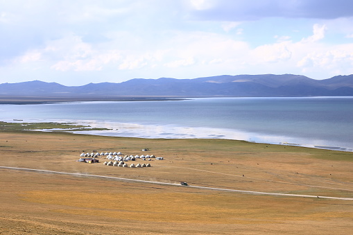 View over Songkol lake, steppe and surrounding mountains in Kyrgyzstan