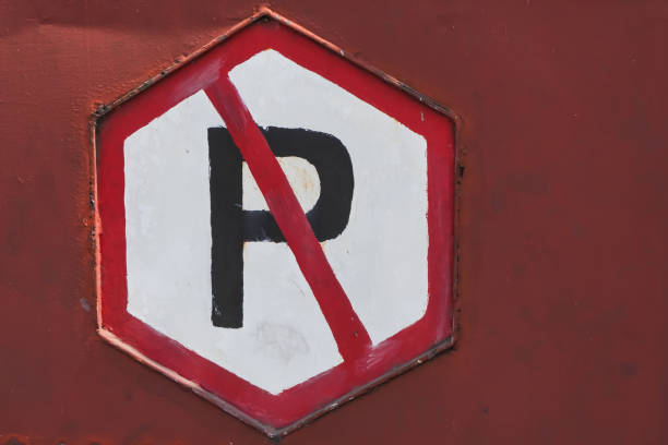 istock No parking sign board with red metallic background. No car and motorcycle allowed. Traffic signs - Prohibition of parking in front of the gate. 1879376324