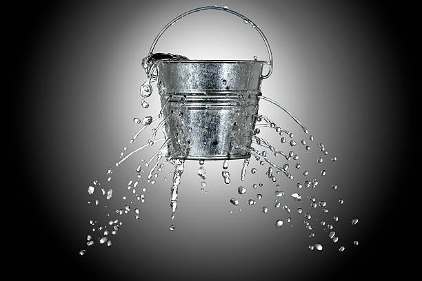 bucket with holes water is coming out of a bucket with holes bucket stock pictures, royalty-free photos & images