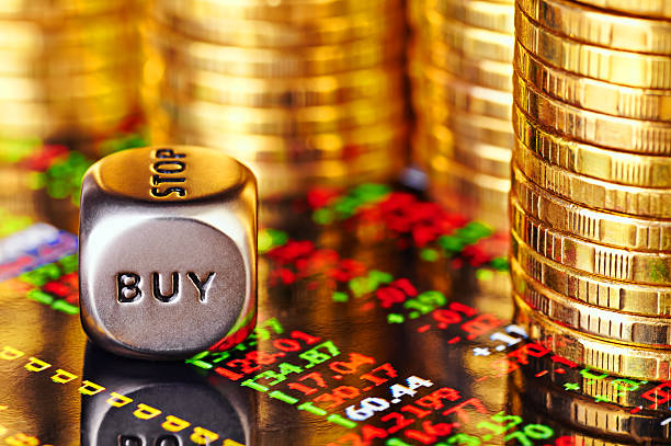 Financial chart, golden coins and dices cube Financial chart, golden coins and dices cube with the word BUY. Selective focus top 10 gold ira companies stock pictures, royalty-free photos & images