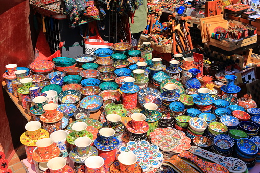 colorful painted traditional decorative Albanian plates and bowls on souvenir stall in Tirana