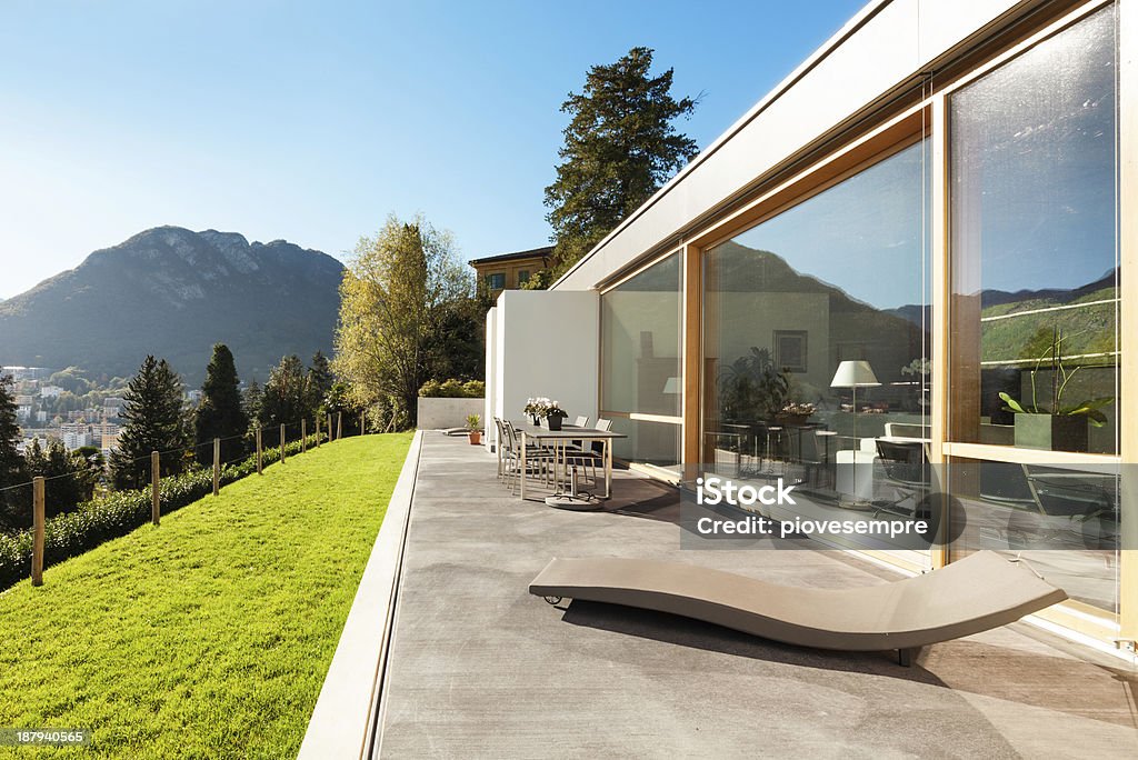 Beautiful modern house, outdoor Beautiful modern house in cement, view from the garden Concrete Stock Photo