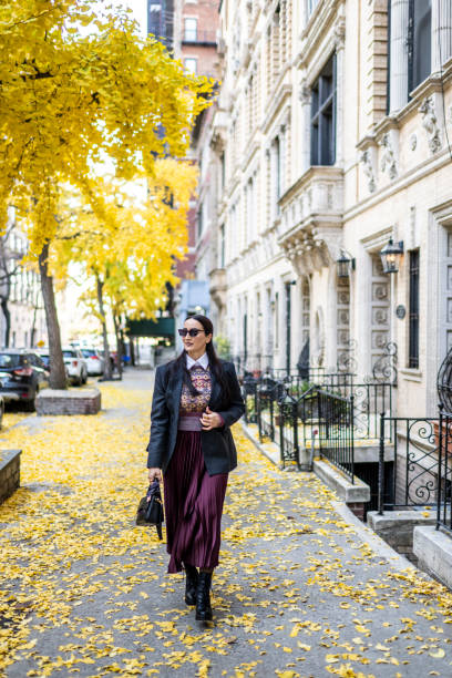 istock Nicely dressed female New Yorker enjoys autumn day 1879417075