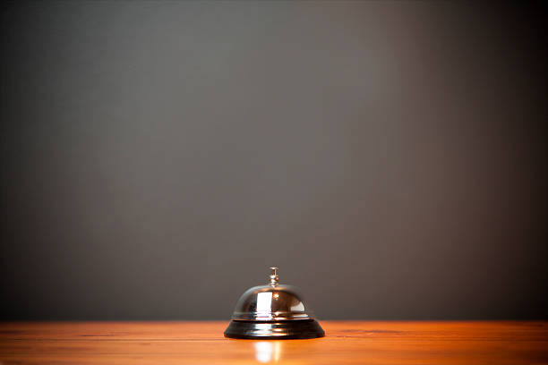 istock Hotel bell isolated on wooden table 187943727
