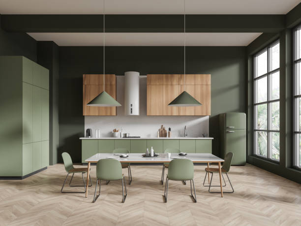 istock Dark green and wooden kitchen interior with dining table 1879438982