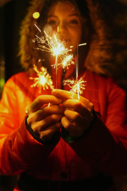 istock Girl holding burning sparkler during Christmas 1879445199