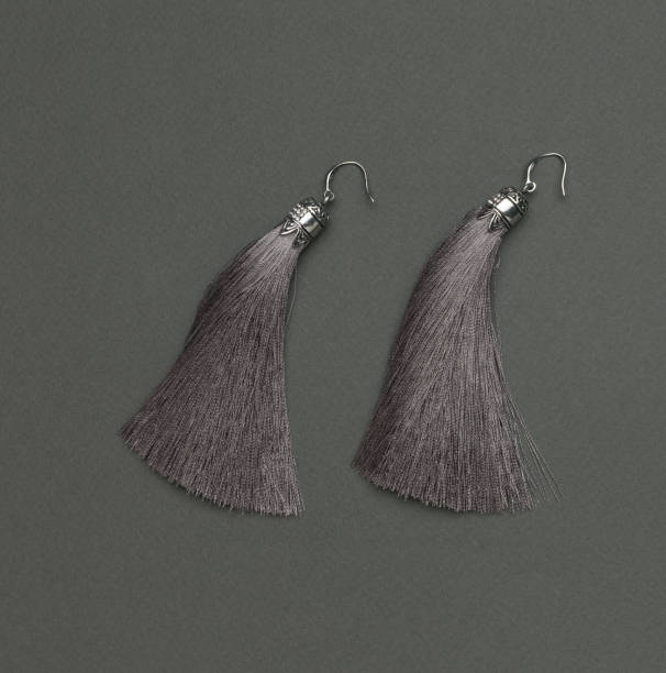 istock Women's earrings made of gray threads on a gray background. 1879446233