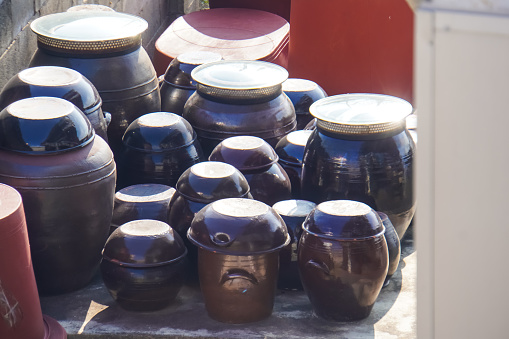 Image of a beautiful Korean jar in the garden. Traditional Korean Kimchi Barrels