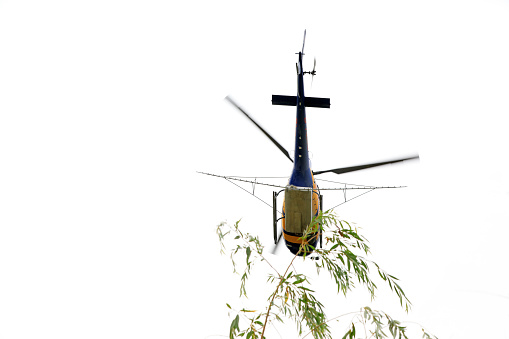 A closeup of four colorful helicopter miniatures isolated on white surface