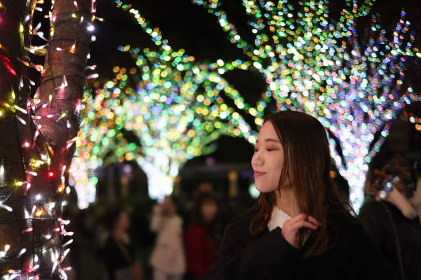 istock Beautiful young lady in Christmas illuminations 1879456610