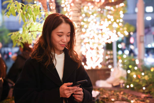 istock Beautiful young lady in Christmas illuminations 1879457135