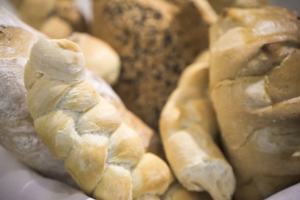 istock Various types of bread on display in a bakery or pastry. Modern bakery with different kinds of bread, cakes and buns. 1879461331
