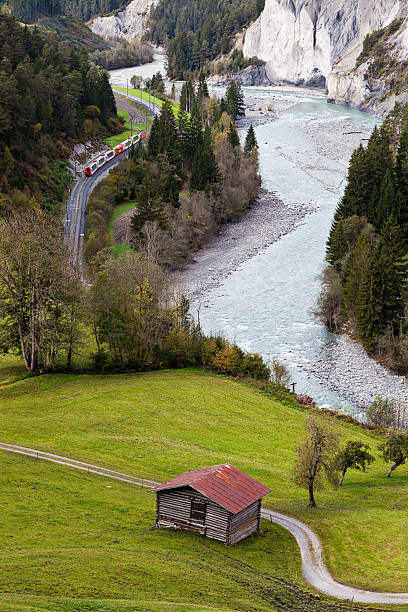 Train passing through Rhine Gorge (Rheinschlucht/Ruinaulta) stock photo