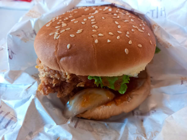 istock Chicken burger on a wrapping paper 1879464380