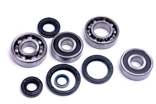 Ball bearings and rubber seals on a white background.