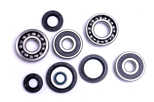Ball bearings and rubber seals on a white background.