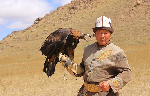 August 27 2023 - Bokonbayevo, Issyk Kul Province in Kyrgyzstan: a Kyrgyz Eagle Hunter with His Eagle