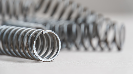 close up of Coiled Spring on gray background