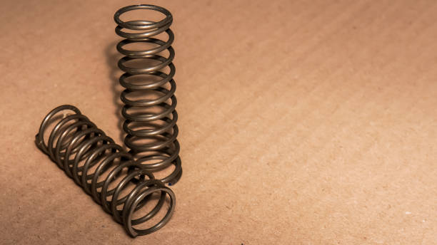 istock metal spring on brown backgroun 1879491420