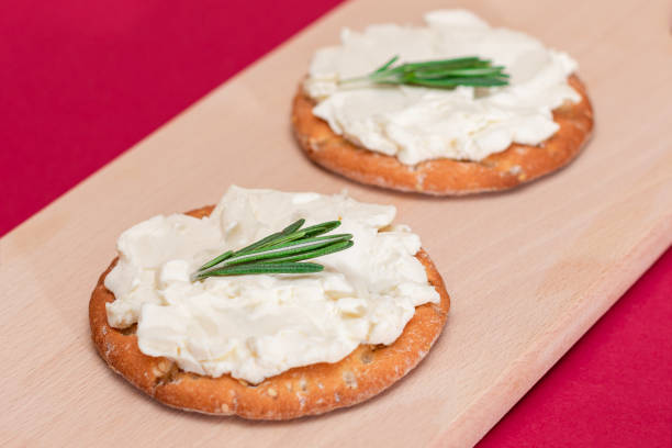 istock Crispy Cracker Sandwich with Cream Cheese and Rosemary 1879495555