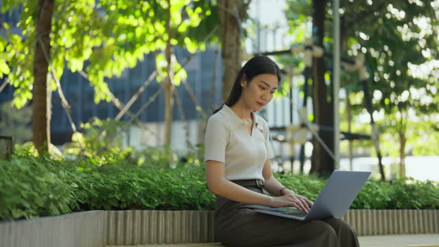 Woman working with a laptop in the serenity of nature.