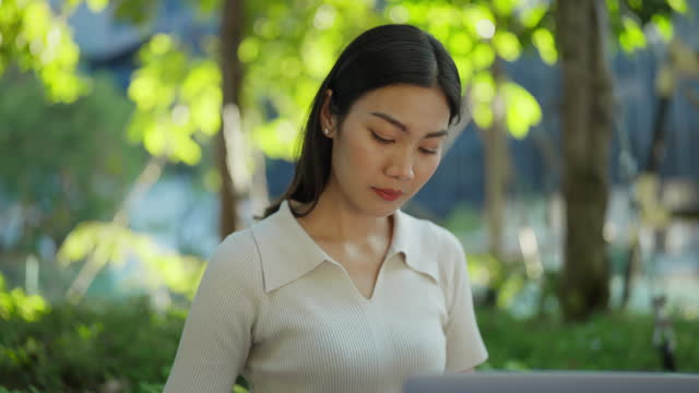 Woman working with a laptop in the serenity of nature.