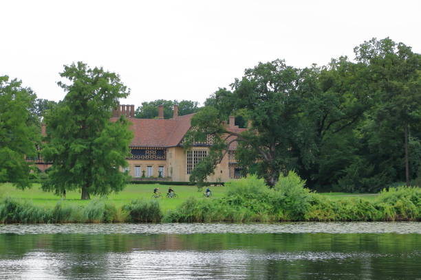 July 31 2023 - Potsdam, Berlin, Brandenburg in Germany: passing the old buildings by boat trip on the Havel River near Glienicke Bridge between Berlin and Potsdam on a cloudy day