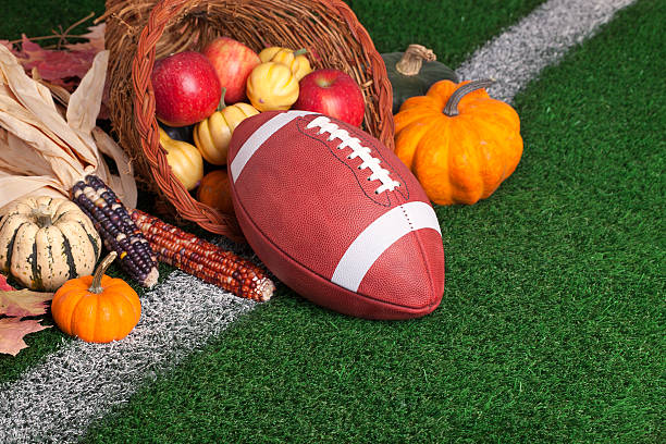 istock College style Football with a cornucopia on grass field 187951285