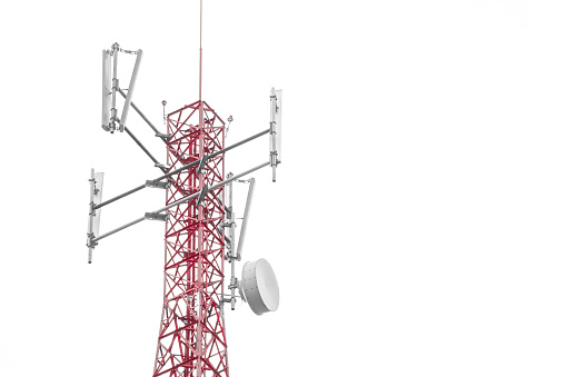 Telecommunication towers include of radio microwave and television antenna system with cloud blue sky and sun ray. Antenna tower, low angle view. Empty blank copy text space.