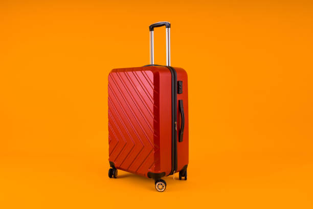 istock Red Suitcase on Vibrant Yellow 1879524034