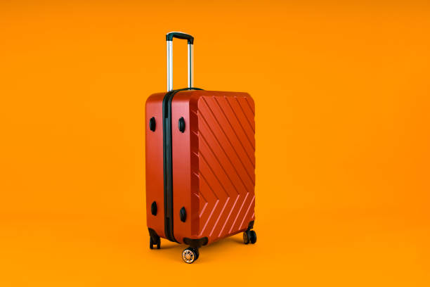 istock Red Suitcase on Vibrant Yellow 1879524035