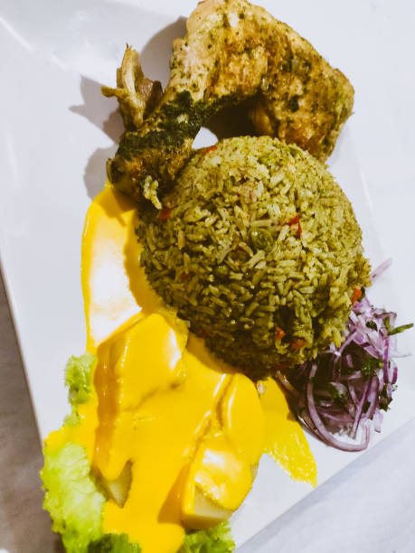 istock Peruvian rice dish with chicken served with red onion, potato and yellow sauce 1879548843