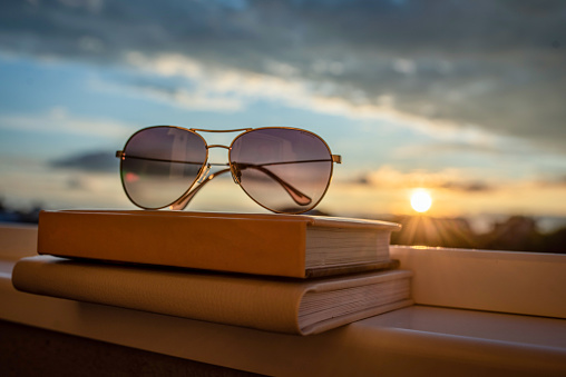 Glasses on a books in the sunset. Relaxing concept.