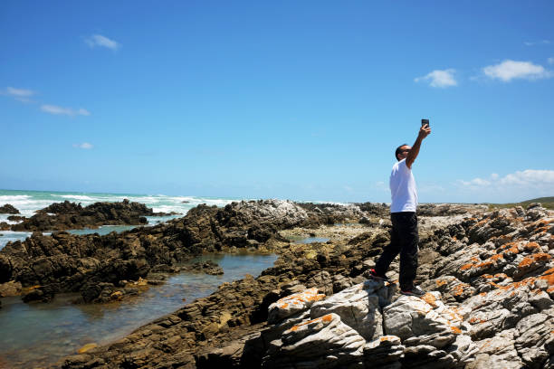 istock Taking photos on the rocks of Cape Aghulas 1879582973