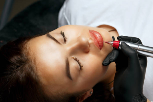 istock Cosmetician applying permanent makeup to a woman 1879586604