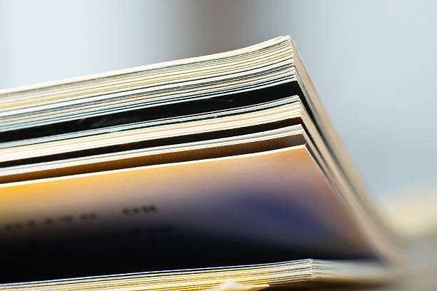 Close-up of blurred magazine pages with crisp edges Close-up of magazine pages. Shallow DOF, focus on edges. editorial stock pictures, royalty-free photos & images