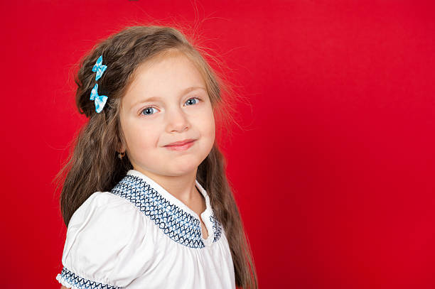 istock smiling girl portrait on red 187959106
